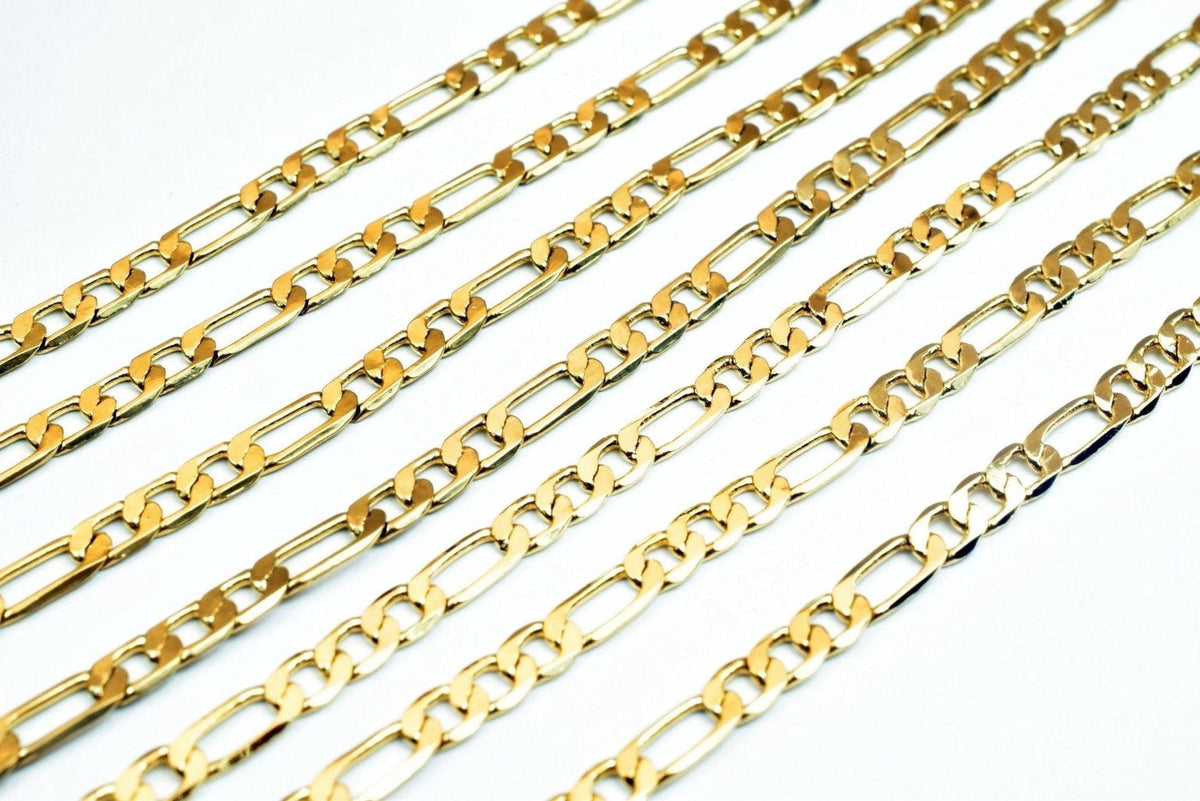 A collection of gold-colored metal chain necklaces arranged in a grid-like pattern against a white background.