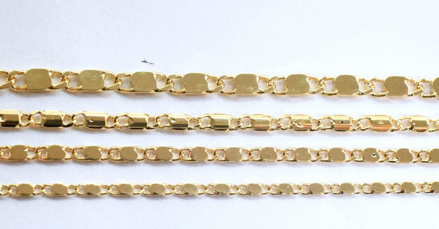 a collection of gold-colored chain links arranged in a row, with varying lengths and designs.