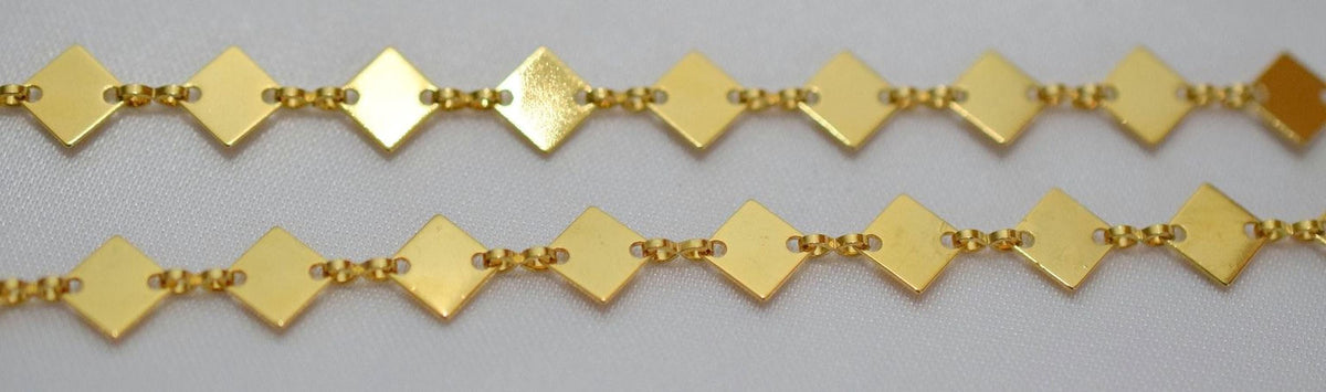 a close-up view of a gold-colored chain with diamond-shaped links arranged in a repeating pattern.
