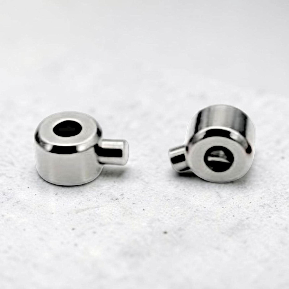 Silver stainless steel bracelet crimp end clasps for cord, chain, and beaded jewelry designs.