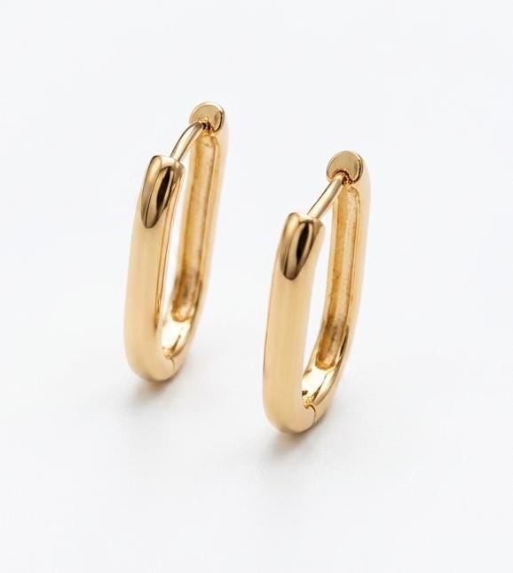 A pair of small, thin 18k gold-filled huggie hoops, ideal for minimalist jewelry or adding small charms.