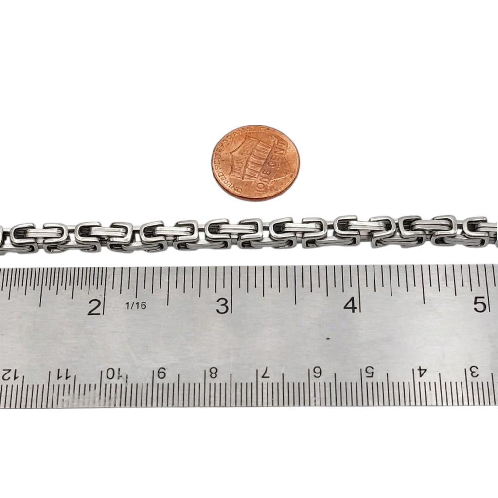 Close-up of shiny interlocking stainless steel chain links.