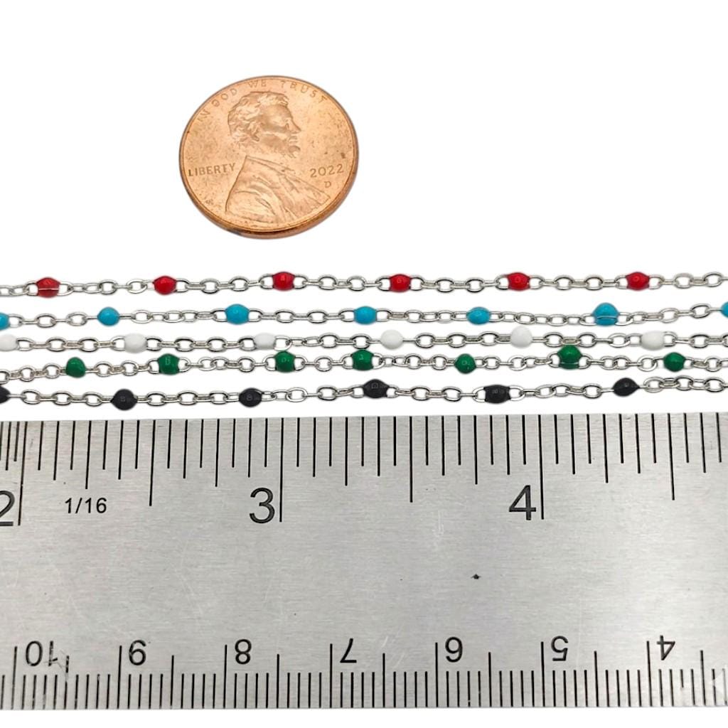 A single strand of the turquoise blue beaded satellite chain held next to a ruler to clearly display the 2mm size scale.