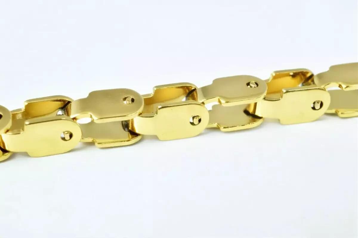 A close-up view of a gold-colored bracelet with a unique clasp design.