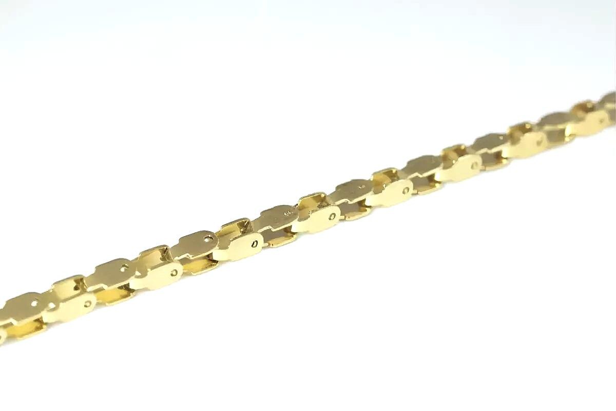 A gold chain necklace with a series of interlocking links.