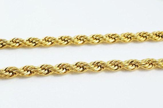 A close-up image of a gold rope chain with twisted braided links.