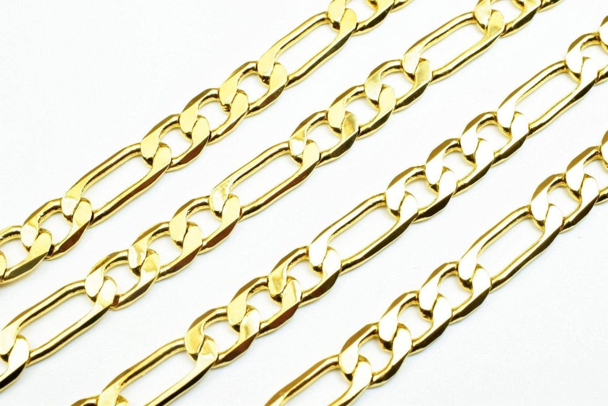 a close-up view of several gold-colored chain necklaces arranged in a diagonal line.