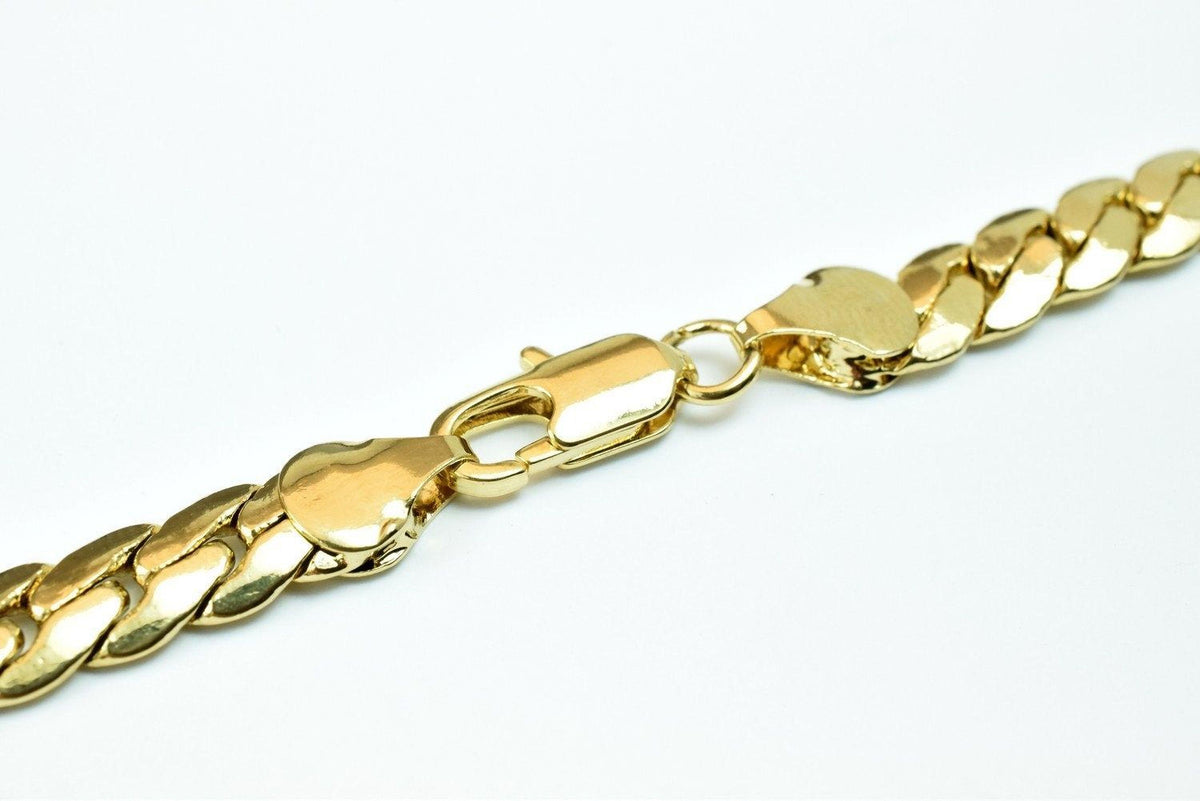 A close-up view of a gold chain necklace with a clasp and lock mechanism.