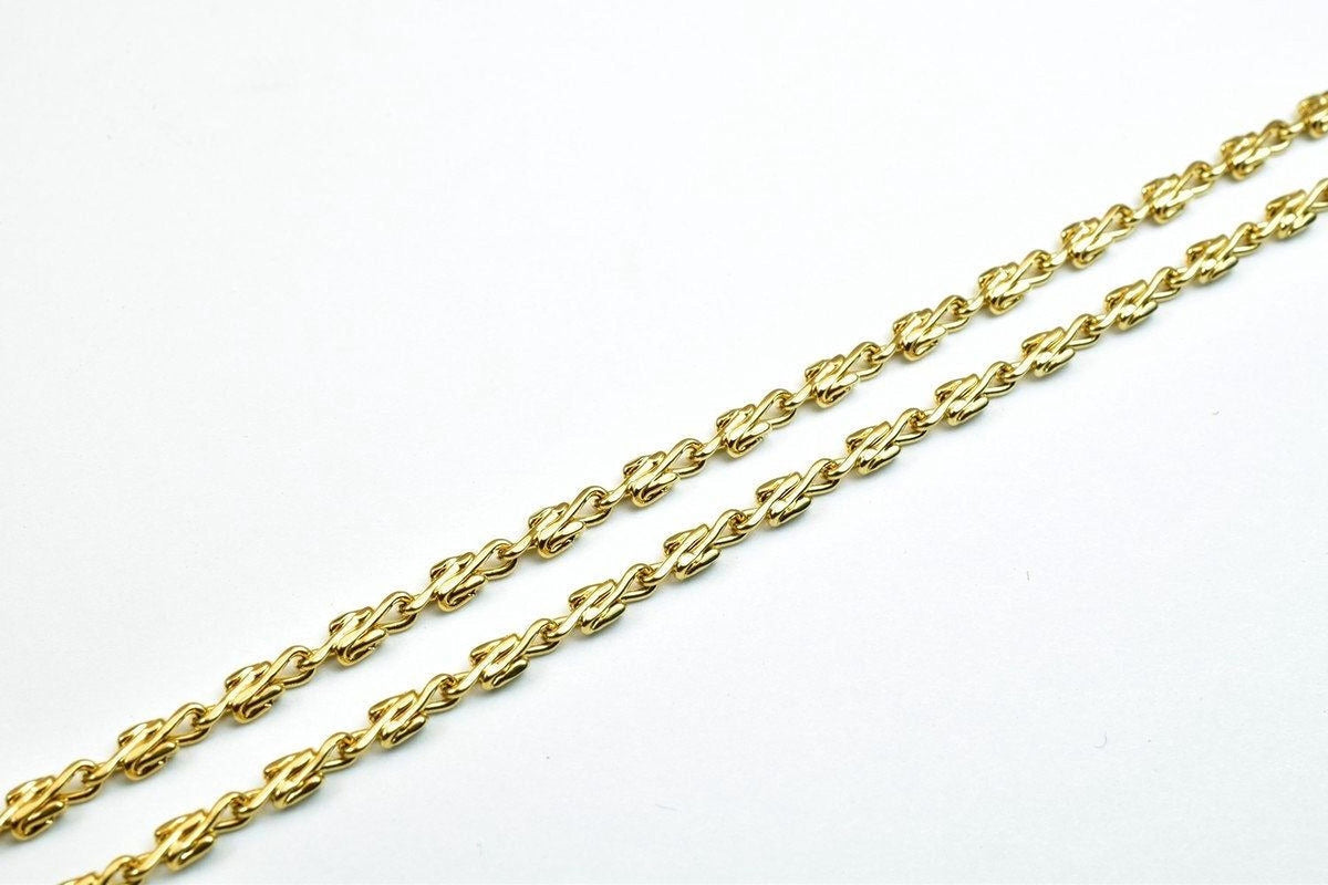 A gold chain necklace with a series of interlocking links, creating a visually appealing and intricate design.