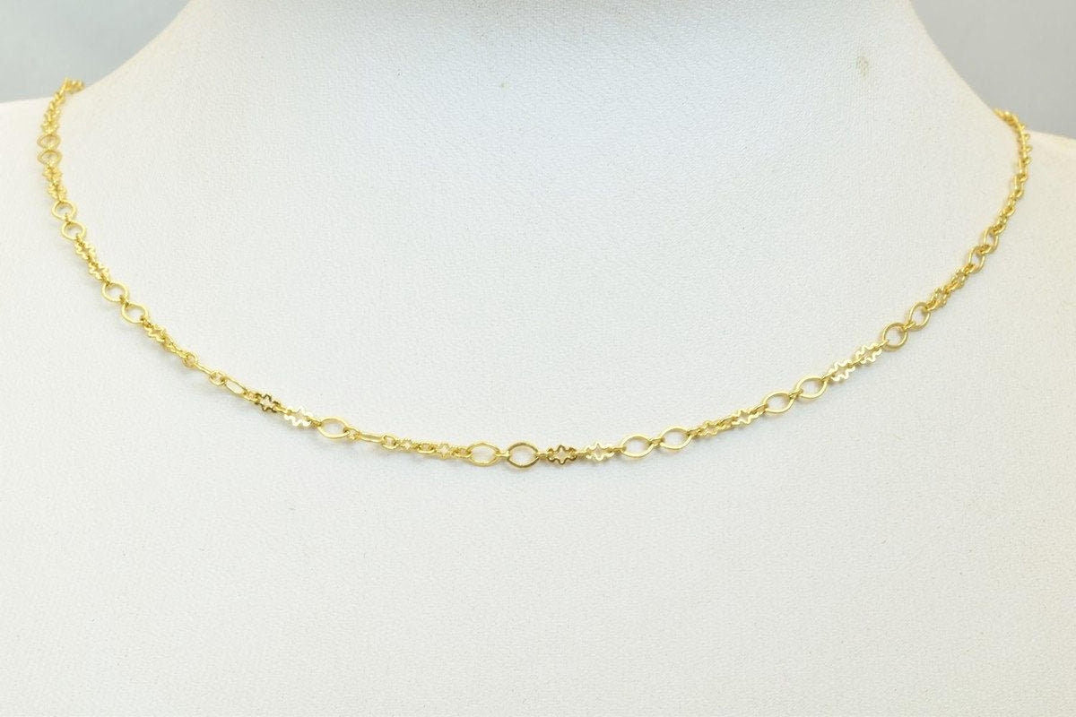A gold chain necklace with a delicate design.