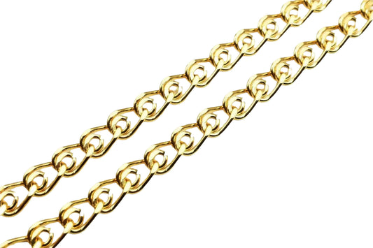 A close-up view of a gold-colored chain with interlocking links, arranged diagonally across a white background.