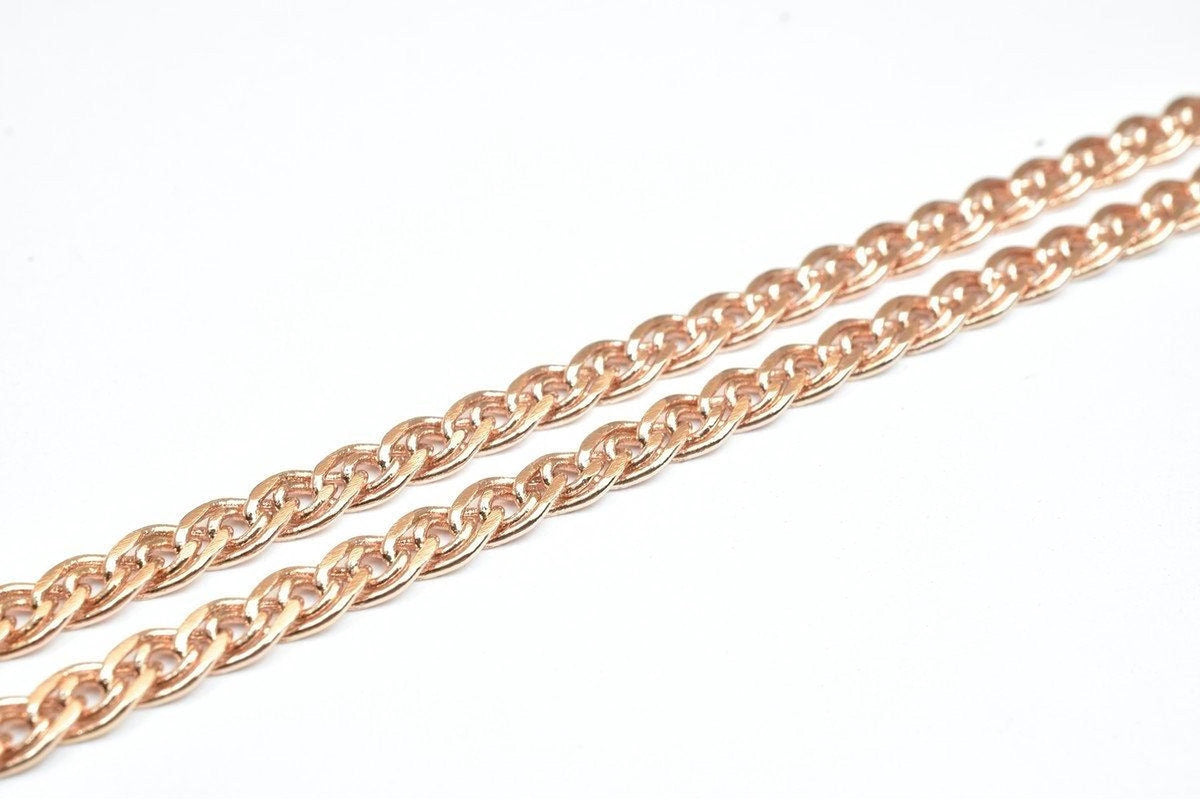 A close-up image of a chain with a metallic, reddish-brown color.