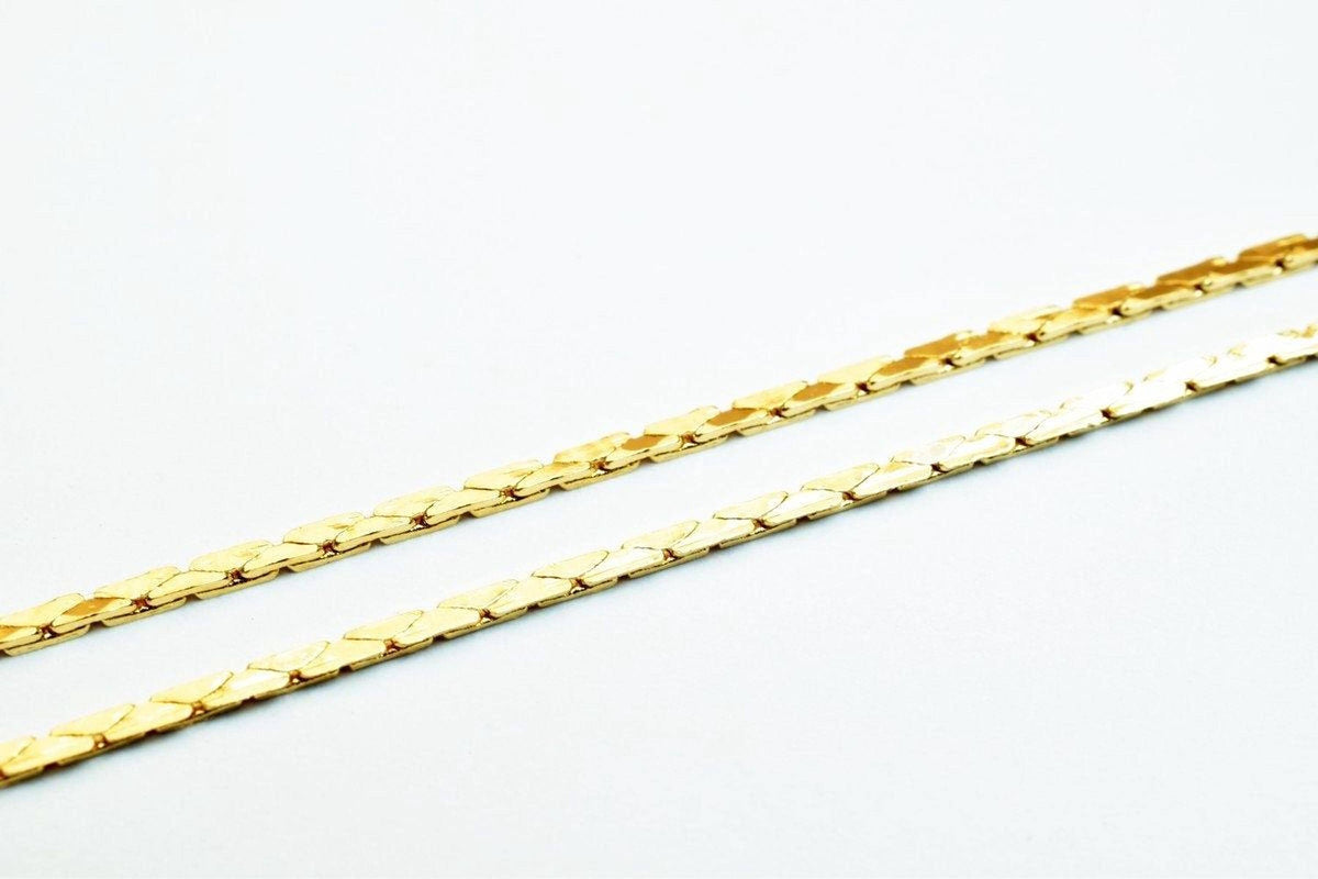 Two gold-colored metal chains are shown against a white background.