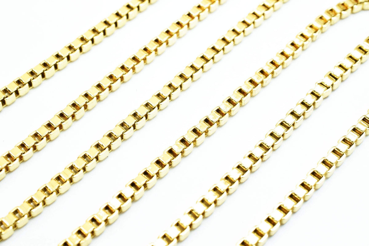 A close-up image of several gold-colored metal chains arranged in a diagonal line.
