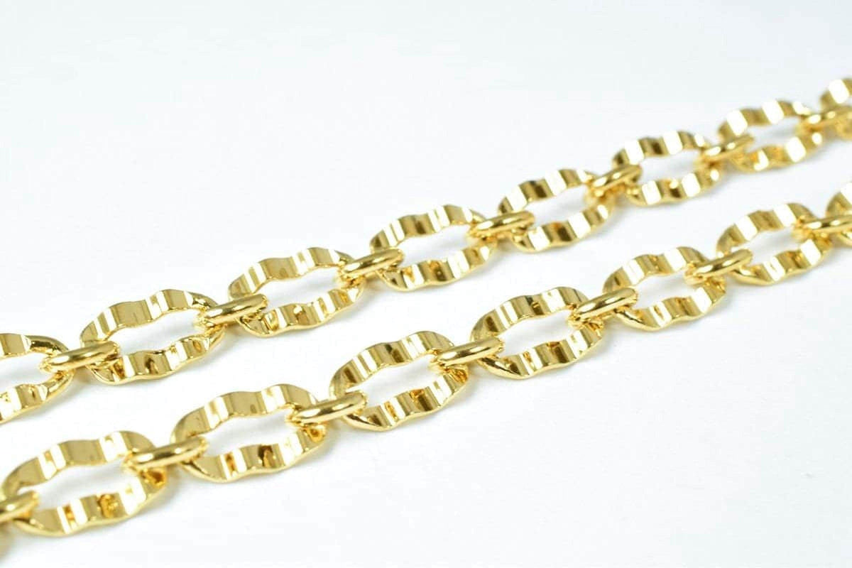 A close-up view of a gold-colored chain with multiple links, showcasing the intricate design and texture of the metal.