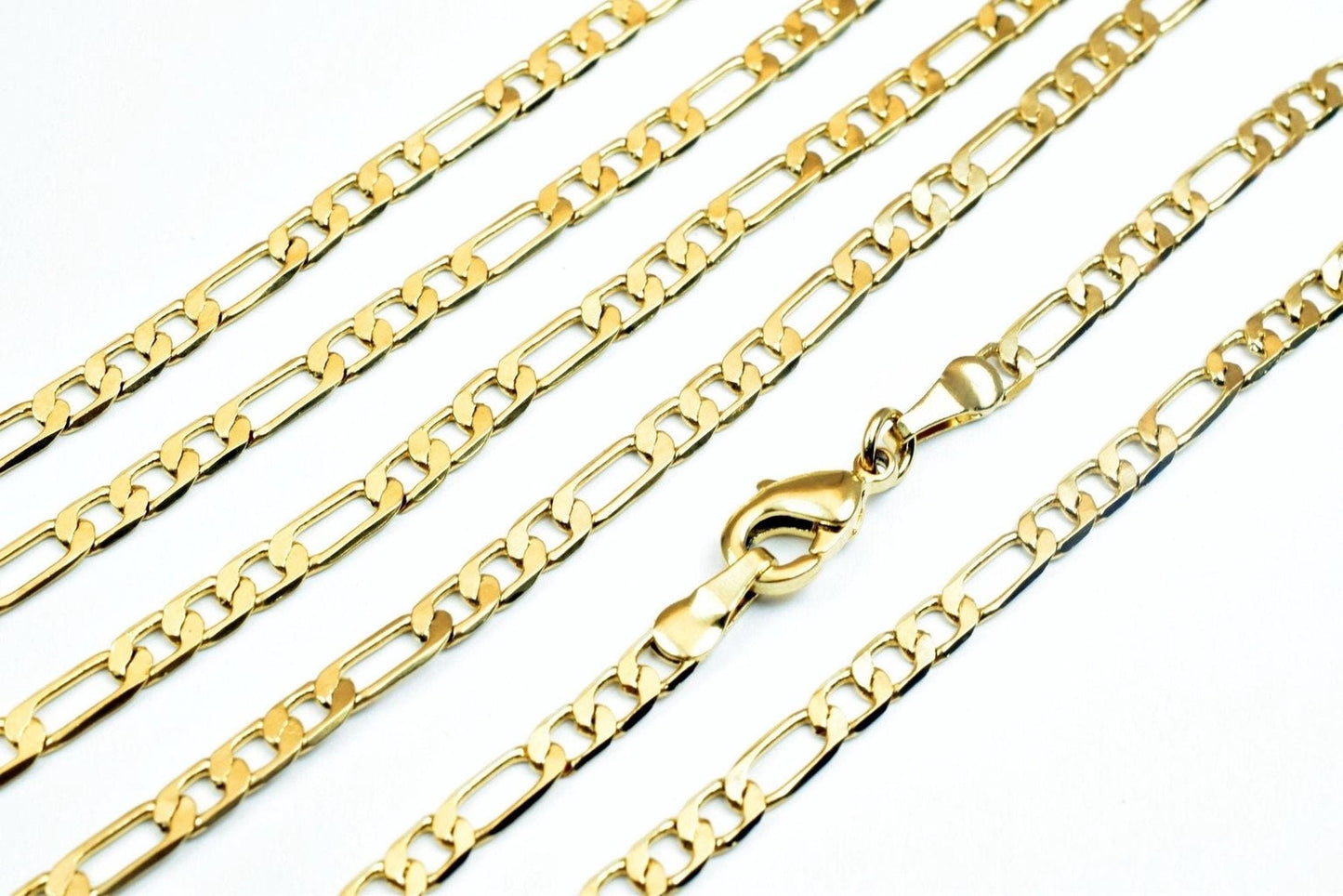 A close-up image of several gold-colored chain necklaces with a clasp visible.