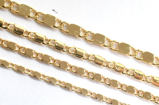 a close-up view of several gold-colored metal chains arranged in a row.