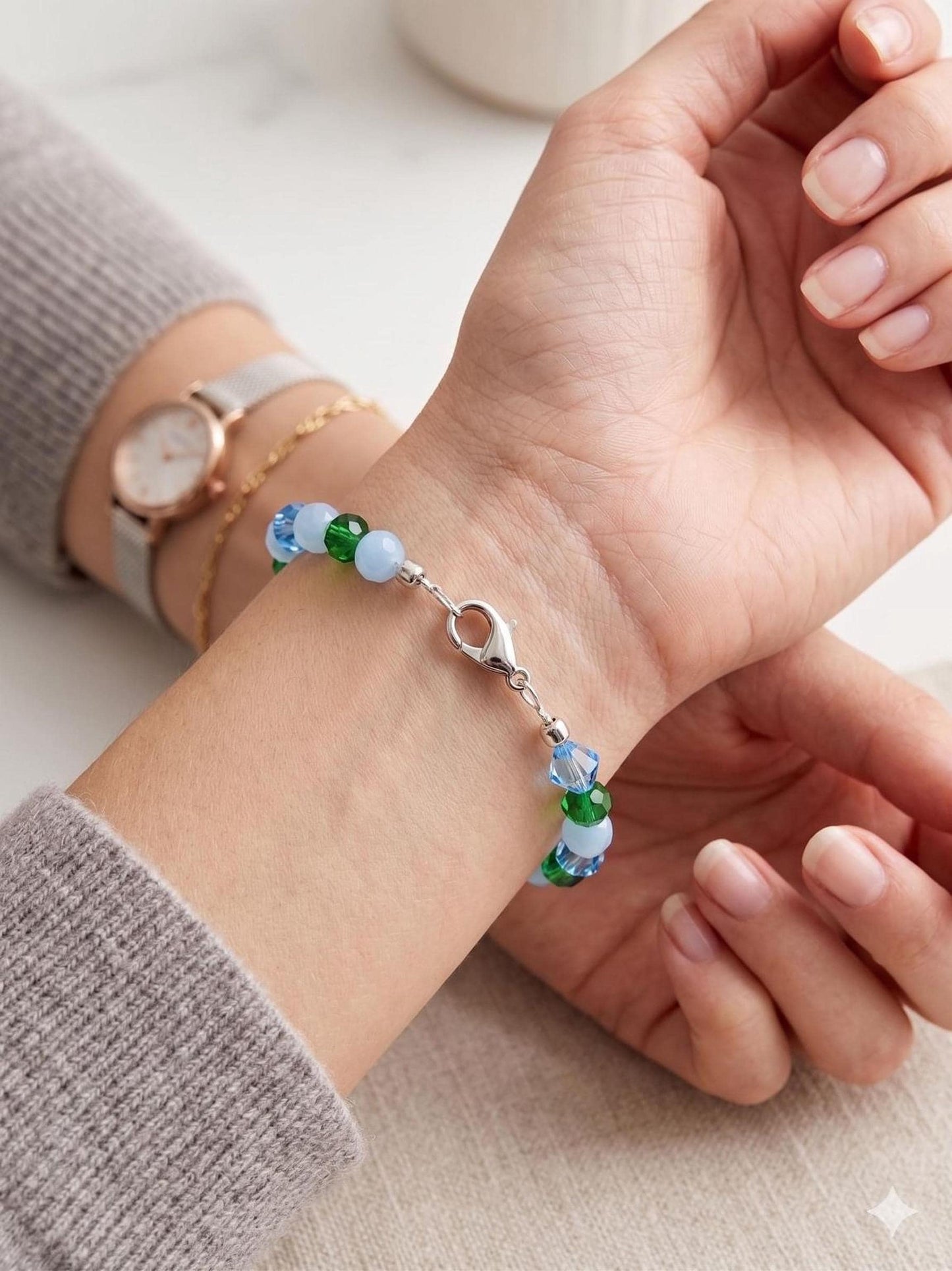 Close-up of a sleek silver stainless steel end locker crimp bead securely fastening the ends of a modern metal wire bracelet, showcasing a clean and professional jewelry-making finish.