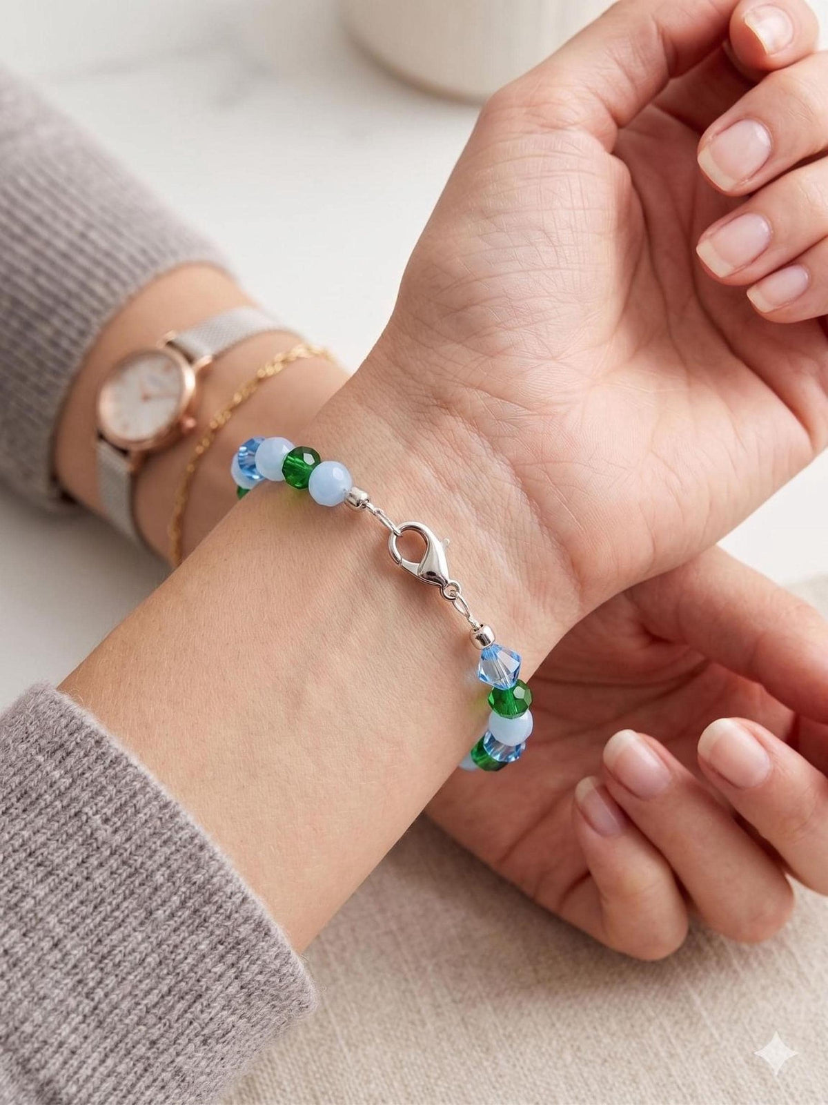 Close-up of a sleek silver stainless steel end locker crimp bead securely fastening the ends of a modern metal wire bracelet, showcasing a clean and professional jewelry-making finish.