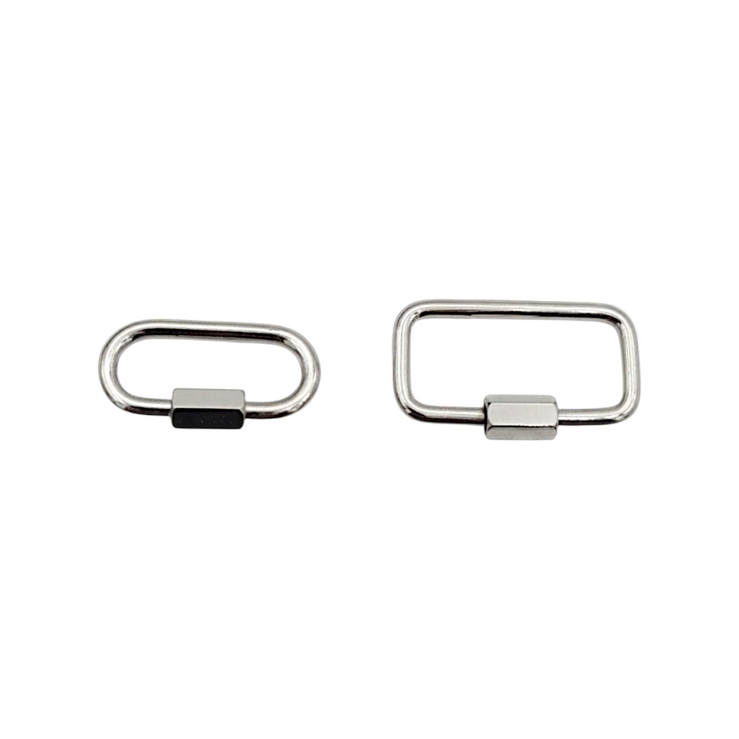 A matching pair of silver stainless steel screw gate connector links laying flat on a clean white surface.