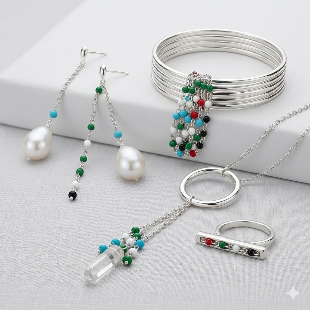 The green and onyx black beaded chains styled as a dainty, layered DIY necklace on a minimalist jewelry bust