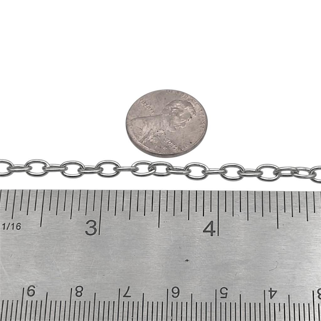 Stainless steel extension chain shown next to a clear ruler measuring link size in millimeters for jewelry making