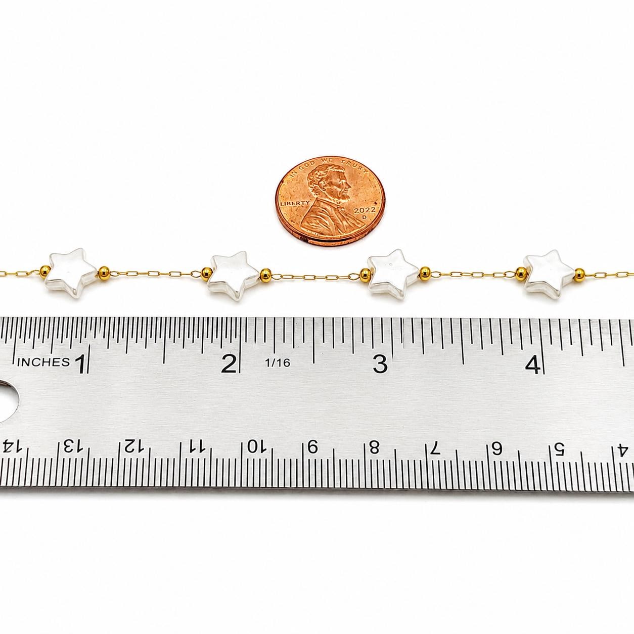 Celestial jewelry chain featuring pearly white stars and polished gold spacer beads.