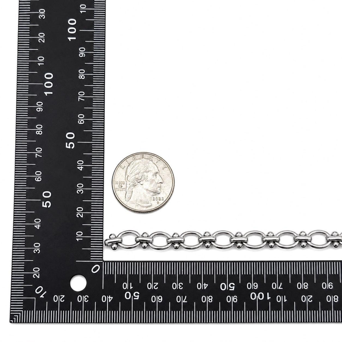 Stainless steel jewelry chain with oval links, bar connectors, and small bead accents