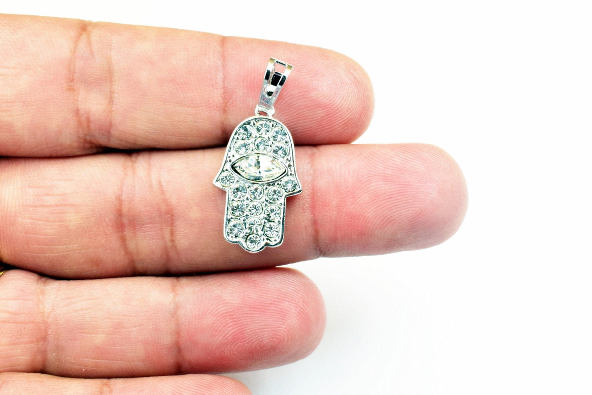 Silver Hamsa hand pendant with cubic zirconia stones.